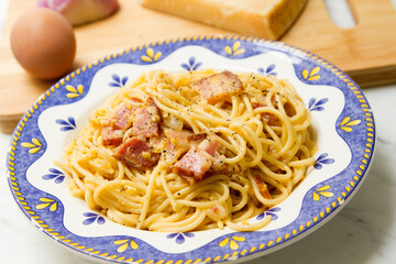 Carbonara pasta. Carbonara is an Italian pasta dish from Rome made with eggs, hard cheese, cured pork, and black pepper.
