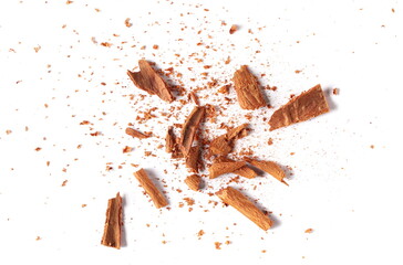 Cinnamon sticks, pieces with shavings isolated on white, top view