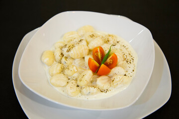 Italian Gnocchi with cheese sauce and cream. Traditional Italian recipe.