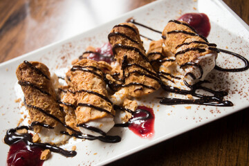 The cannolo is a typical sweet from the Italian region of Sicily, where it originates from. It consists of a rolled dough in the shape of a tube that contains ingredients mixed with ricotta.