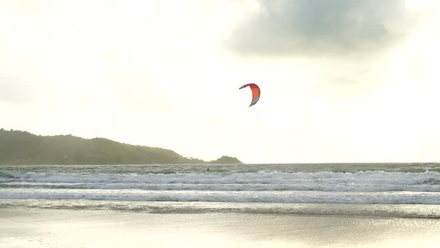 Tourists parasailing flying sky during sunset mountain background. Summer holiday vacation concept.