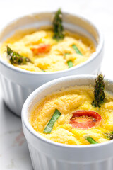 baked eggs with green asparagus, tomato and spring onion