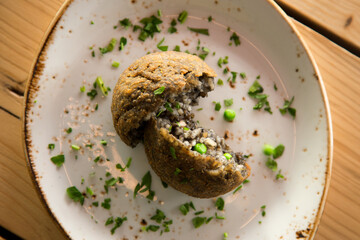 Cuttlefish black Arancini. Arancini are a specialty of Sicilian cuisine. They are stuffed breaded and fried rice balls or cones.
