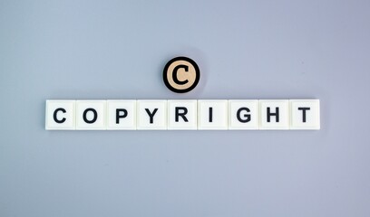 alphabet letters of the word copyright with the letter c above. concept of ownership. the concept...