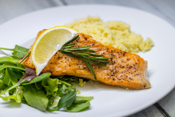 grilled salmon served with couscous and vegetables salad
