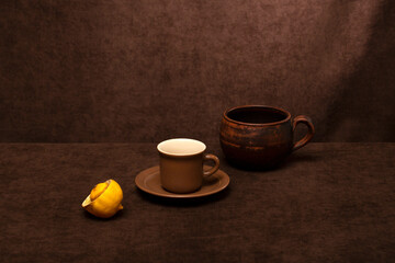 Still life with brown cups and lemon