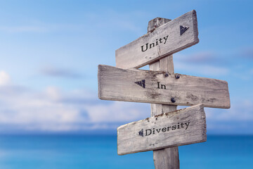 unity in diversity text quote on wooden signpost crossroad by the sea