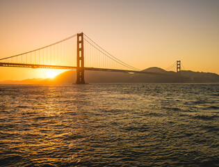 Sunset behind Golden Gate Bridge in San Francisco, USA
