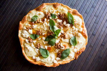 Sweet pizza with fresh cheese, nuts and honey. Neapolitan pizza made with Italian Recipe.