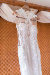 wedding dress on hanger on a wall.