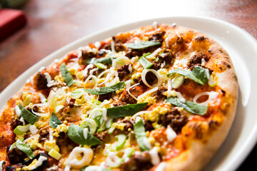 Pizza with meat and vegetables curry. Neapolitan pizza made with mozzarella. Italian recipe.