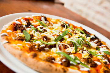 Pizza with meat and vegetables curry. Neapolitan pizza made with mozzarella. Italian recipe.