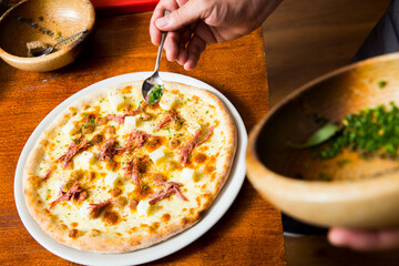 Pizza with arugula meat and cheese. Neapolitan pizza made with mozzarella. Italian recipe.