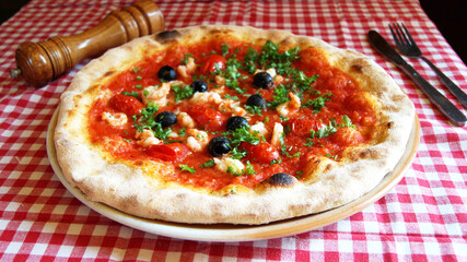 Salmon Pizza. Neapolitan pizza made with salmon and baked vegetables. Italian vegetarian recipe.