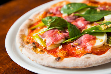 Pizza beef carpaccio. Neapolitan pizza made with tomato sauce, cheese and beef. Italian recipe.