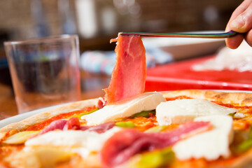 Pizza beef carpaccio. Neapolitan pizza made with tomato sauce, cheese and beef. Italian recipe.