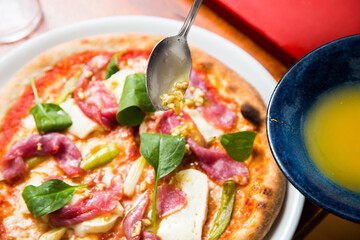 Pizza beef carpaccio. Neapolitan pizza made with tomato sauce, cheese and beef. Italian recipe.