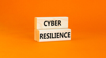 Cyber resilience symbol. Concept word Cyber resilience typed on wooden blocks. Beautiful orange table orange background. Business and cyber resilience concept. Copy space.