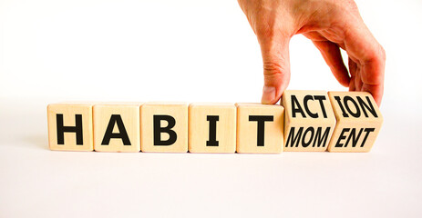 Habit action and moment symbol. Concept words Habit action Habit moment on wooden cubes. Businessman hand. Beautiful white table white background. Business habit action moment concept. Copy space.