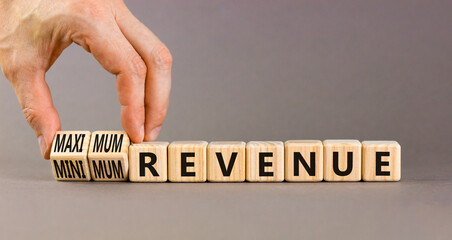 Maximum or minimum revenue symbol. Concept words Maximum revenue and Minimum revenue on wooden cubes. Beautiful grey table grey background. Business maximum or minimum revenue concept. Copy space.