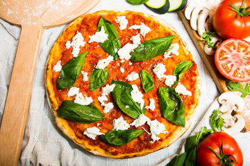 Bufala Mozzarella Pizza. Neapolitan pizza made with tomato sauce, mozzarella cheese and some vegetables. Italian recipe.