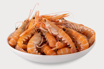 Langoustines, raw scampi in white dishready to be cooked,  isolated on white, top view with...