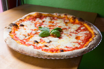 Margherita Pizza. Neapolitan pizza made with San Marzano tomatoes, mozzarella cheese, fresh basil, salt and extra virgin olive oil.