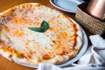 Margherita Pizza. Neapolitan pizza made with San Marzano tomatoes, mozzarella cheese, fresh basil, salt and extra virgin olive oil.