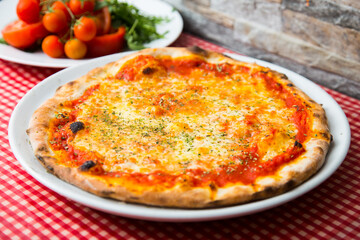 Margherita Pizza. Neapolitan pizza made with San Marzano tomatoes, mozzarella cheese, fresh basil, salt and extra virgin olive oil.