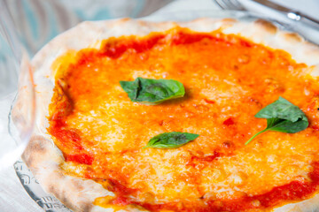 Margherita Pizza. Neapolitan pizza made with San Marzano tomatoes, mozzarella cheese, fresh basil, salt and extra virgin olive oil.