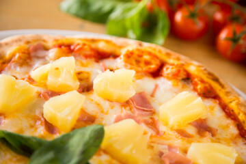 Prosciutto and pineapple Pizza. Neapolitan pizza with tomato sauce, cheese and prosciutto ham. Authentic Italian recipe.