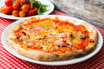 Prosciutto Pizza. Neapolitan pizza with tomato sauce, cheese and prosciutto ham. Authentic Italian recipe.