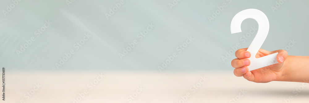 Aufkleber Number two in hand. Hand holding white number 2 on blurred background with copy space. Concept with number two. 2 percent, birthday 2 years old, couple, two, double