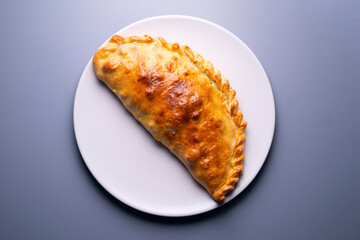 Calzone Pizza. Neapolitan pizza stuffed with cheese, tomato and other ingredients such as meat or vegetables. Authentic Italian recipe.
