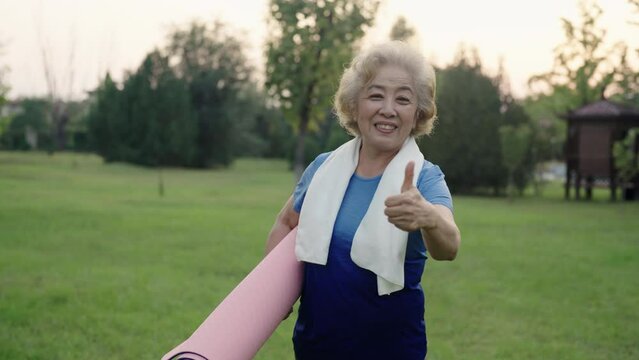 Happy senior Chinese woman exercising in park,4K