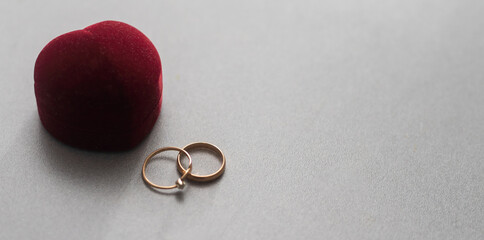 Two wedding rings in nice red box isolated on white background.