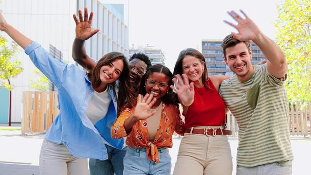 Group of teenagers saluting waving hands gesturing hello, hi, greeting with happy expression. Multiracial student friends looking at camera saying goodbye. High quality 4k slowmotion footage