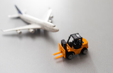 Fototapeta premium miniature toy excavator and plane. Industry concept.