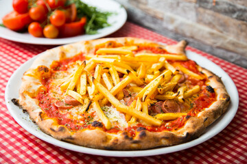 Sausage Pizza with fries on the top. Neapolitan pizza with tomato sauce, cheese, pork sausage meat. Authentic Italian recipe.
