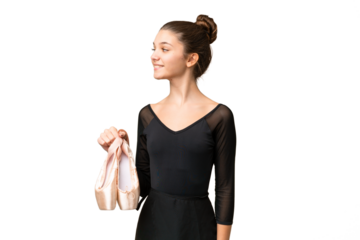 Teenager girl practicing ballet over isolated chroma key background looking side