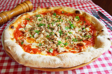 Tuna Pizza. Neapolitan pizza with mozzarella cheese, tuna, onion and olives. Authentic Italian recipe.