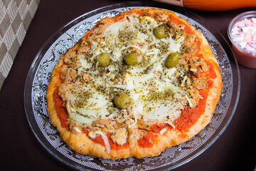 Tuna Pizza. Neapolitan pizza with mozzarella cheese, tuna, onion and olives. Authentic Italian recipe.