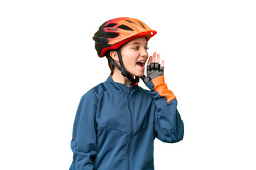 Teenager cyclist girl over isolated chroma key background shouting with mouth wide open to the lateral