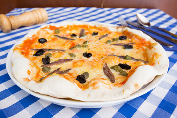Anchovy Pizza. Neapolitan pizza with mozzarella cheese and anchovies from the Mediterranean Sea. Authentic Italian recipe.