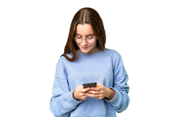 Fototapeta premium Teenager girl over isolated chroma key background sending a message with the mobile