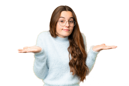 Teenager girl over isolated chroma key background having doubts while raising hands