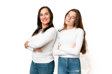 mother and daughter over isolated chroma key background keeping the arms crossed in lateral position while smiling