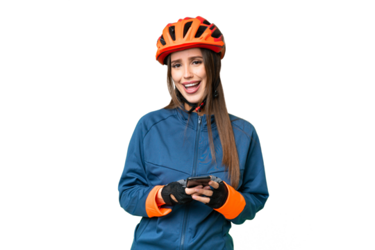 Young cyclist woman over isolated chroma key background surprised and sending a message