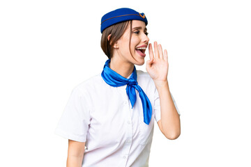 Airplane stewardess over isolated chroma key background shouting with mouth wide open to the lateral