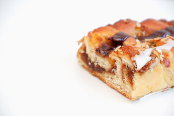 Delicious cake with peanut butter cream layer and chocolate topping. Bakery white background. Selective focus